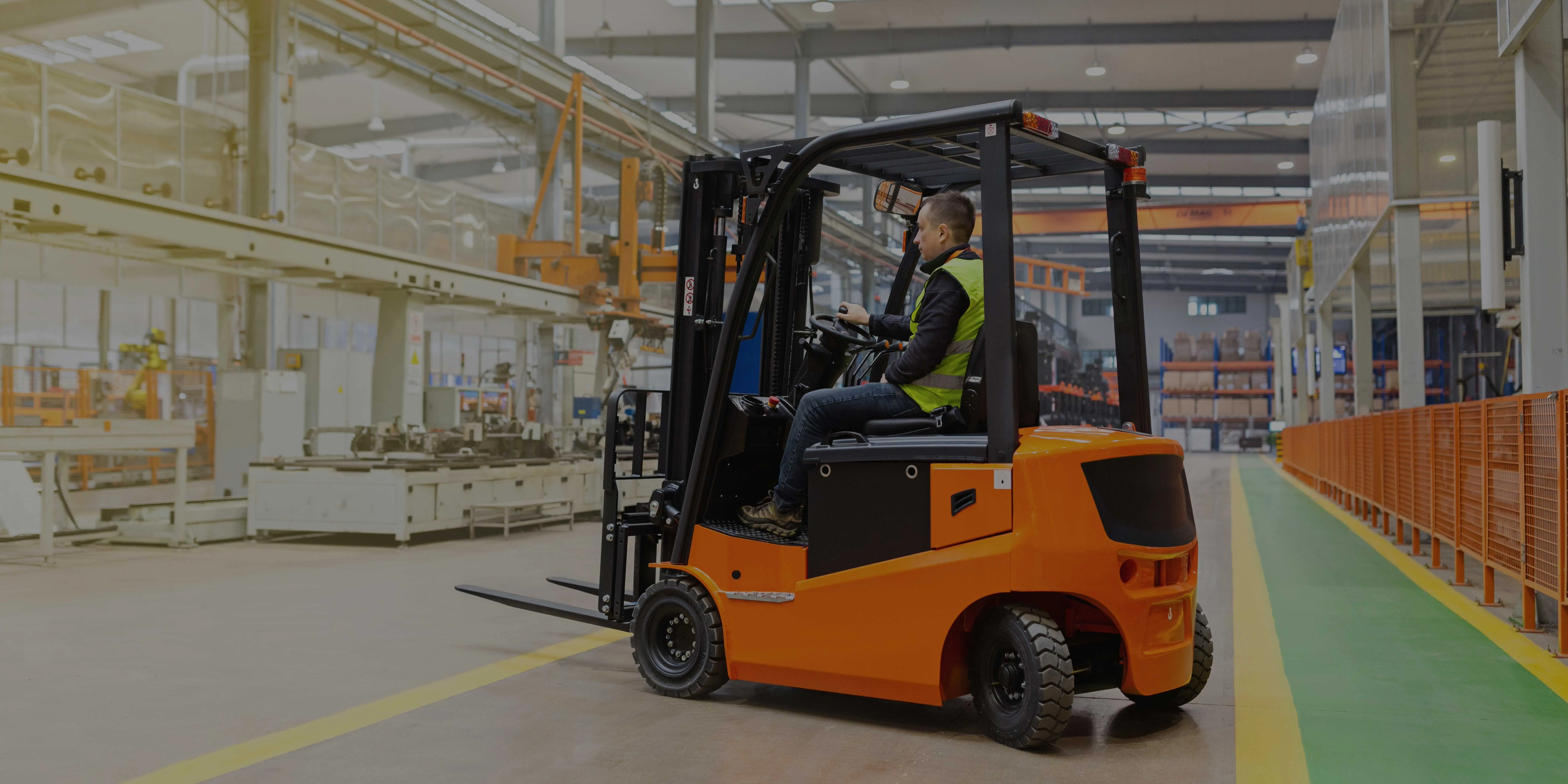 Forklift driver operating a forklift truck in a warehouse