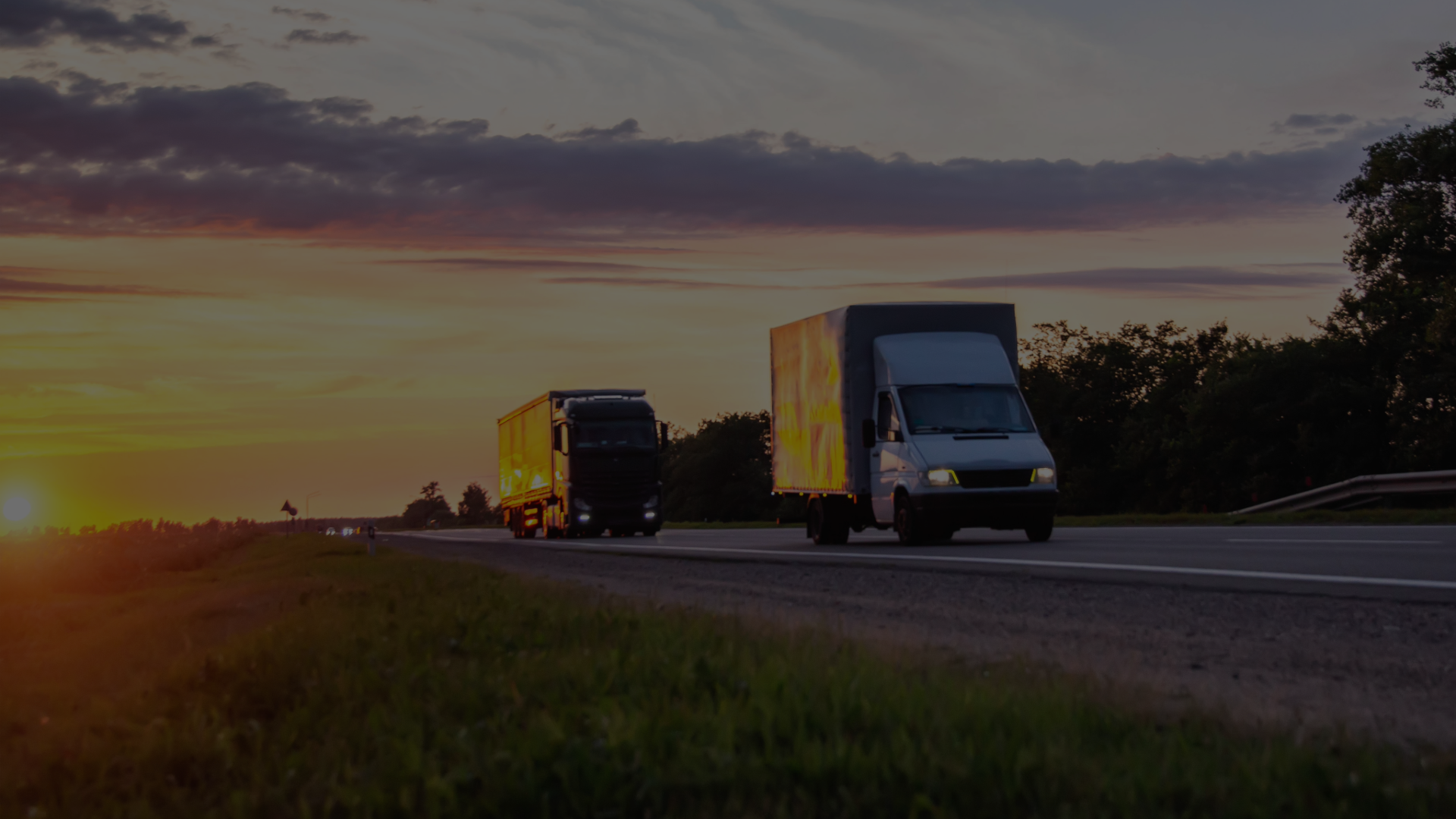 Lorries on a UK road at dusk, the driving work DROPP recruits for