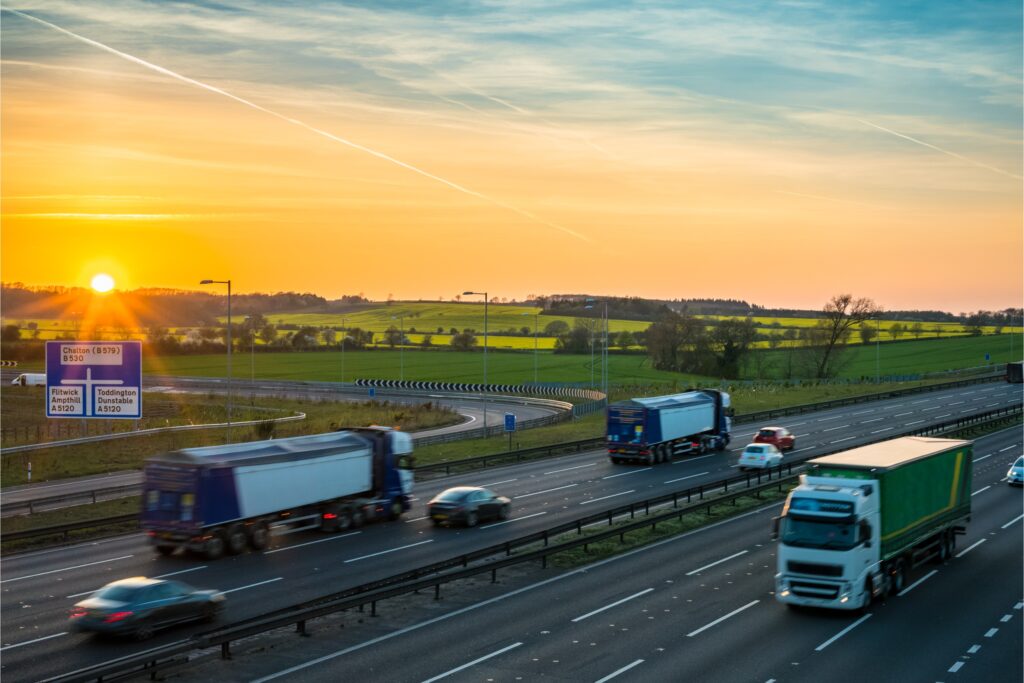 HGV lorries on a UK motorway at sunset