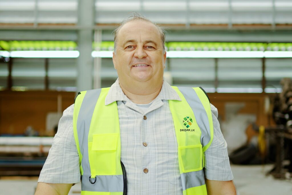 Warehouse operative in a DROPP hi-vis vest inside a UK warehouse
